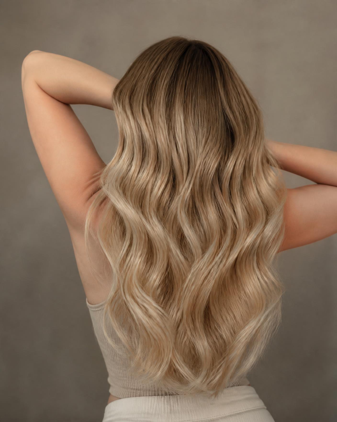 Long wavy blonde balayage hair styled at The Hair Studio by Rosie